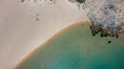 Aerial view of the Sardinian coast. Crystal clear sea of ​​Chia beach. Calm and sunny sea