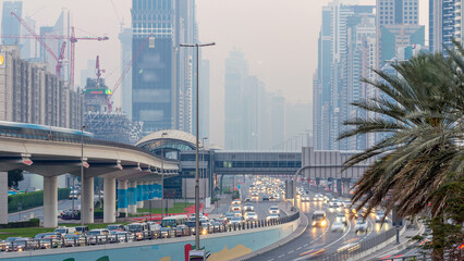 Traffic on intersection and bridge at the Sheikh Zayed Road day to night timelapse