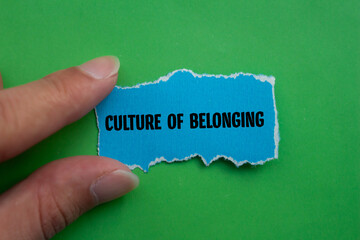 Culture of belonging words written on blue torn paper piece with green background. Conceptual business symbol. Copy space.