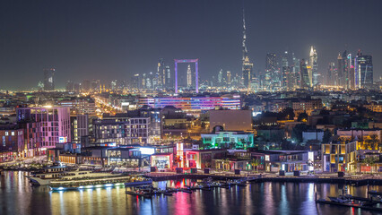 Fototapeta na wymiar Dubai creek landscape night timelapse with boats and ship near waterfront