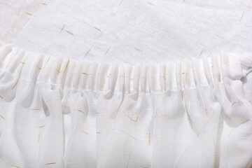 Frills of white fabric. Flounces and ruffles of delicate curtains.