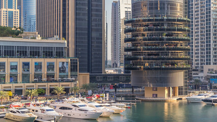 Aerial view of Dubai Marina with shopping mall, restaurants, towers and yachts timelapse, United...