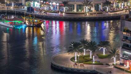 Luxury Dubai Marina canal with passing boats and promenade night timelapse, Dubai, United Arab Emirates © HyperlapsePro