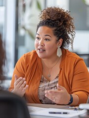 A mixed-race female office worker having a conversation with other co-workers in the office. sharing of ideas, concepts, and thoughts.