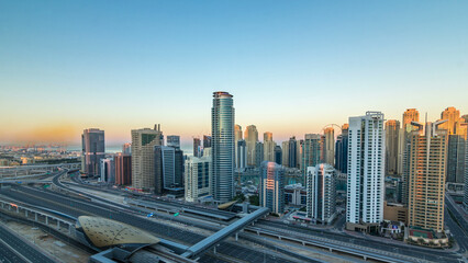Naklejka na ściany i meble Dubai Marina skyscrapers aerial top view at sunrise from JLT in Dubai timelapse, UAE.