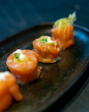 Delicious gourmet Sushi in a black table with black plates