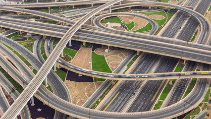 Aerial view of highway junction with traffic timelapse in Dubai, UAE, at sunset. Famous Sheikh...