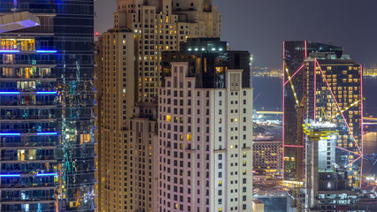 Fototapeta na wymiar Aerial view of modern skyscrapers and beach at Jumeirah Beach Residence JBR night timelapse in Dubai, UAE
