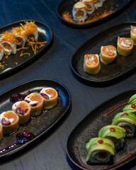 Delicious gourmet Sushi in a black table with black plates