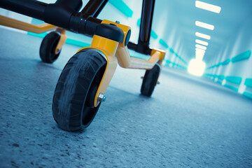 High-Tech Yellow and Black Medical Stretcher in a Brightly Lit Hospital Hallway