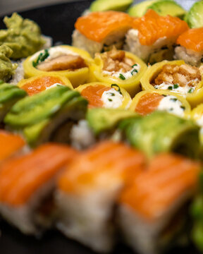 Close up macro shot of delicious gourmet Sushi in a black table with black plates