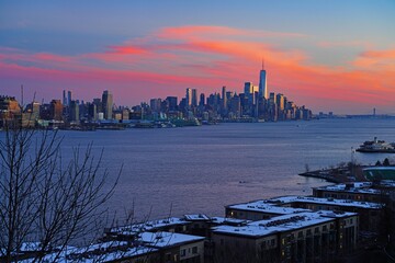 WEEHAWKEN, NJ -18 FEB 2024- Sunset view of the waterfront skyline in Manhattan, New York, seen from across the Hudson River in New Jersey.