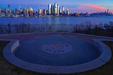 WEEHAWKEN, NJ -18 FEB 2024- Sunset view of the waterfront skyline in Manhattan, New York, seen from across the Hudson River in New Jersey. - 767145487