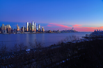 WEEHAWKEN, NJ -18 FEB 2024- Sunset view of the waterfront skyline in Manhattan, New York, seen from across the Hudson River in New Jersey. - 767145625