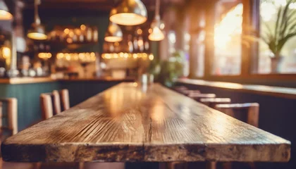 Foto op Plexiglas bar table interior in pub with wooden counter background desk space blurred light for drink design cafe top in coffee restaurant vintage retro style wine shop brown alcohol abstract blurry kitchen © Aedan
