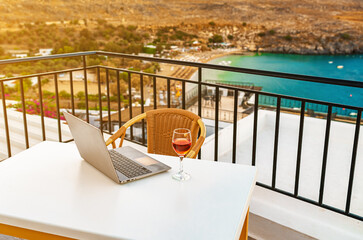 Laptop and a glass of wine. An ideal place for remote work. - 767149840