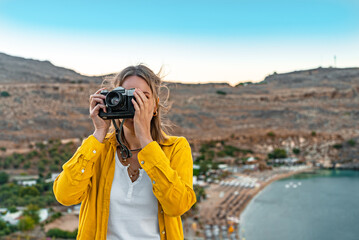 Woman photographer takes pictures on vacation. - 767149846