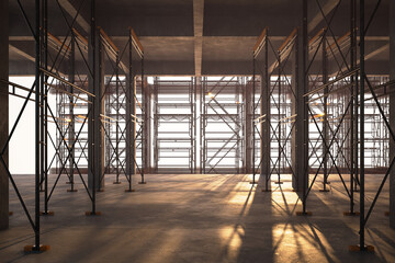 Vast Empty Industrial Construction Site Interior with Sunlight and Shadows