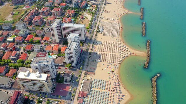 4k drone flying over footage (Ultra High Definition) of Montesilvano public beach. Wonderful morning seascape of Adriatic sea, Italy, Europe. Vacation concept background..
