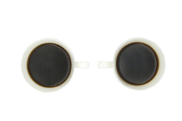 two carved porcelain coffee cup with black coffee poured into it without a background