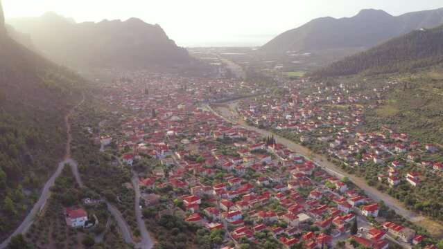 4k drone forward video (Ultra High Definition) of sunrise in Leonidio town. Splendid summer morning in Peloponnese peninsula, Greece, Europe. Traveling concept background.