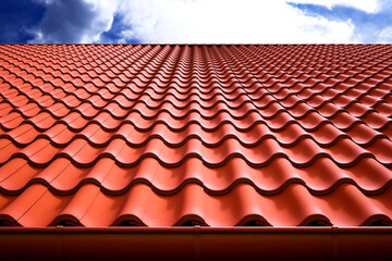 Vibrant Perspective of Red Terracotta Roof Tiles Against a Clear Blue Sky