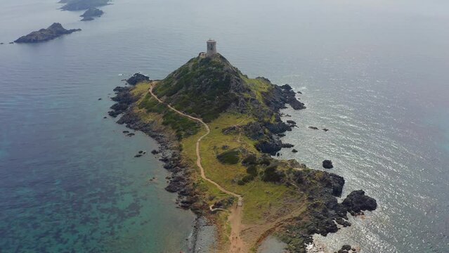 4k drone flight moving to the side footage (Ultra High Definition) of popular tourist destination Torra di a Parata - 16th-century Genoese tower reached by a rocky nature trail, Corsica island, France