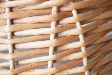Texture of a wicker basket made of willow branches close-up. Abstract background