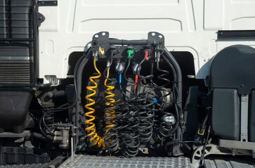 Pneumatic and electrical hoses and cables connecting truck and trailer