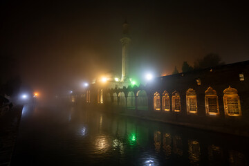 Fototapeta na wymiar Balikligol in Sanliurfa in foggy weather at night.