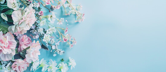 A floral frame on the left side of an empty blue background, colorful flowers in pastel colors, soft lighting, high resolution photography in the style of insanely detailed photography