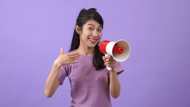 Young Asian woman holding mega phone to announce
