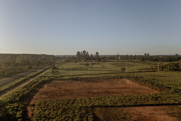 drone view of dirt field and blue sky
