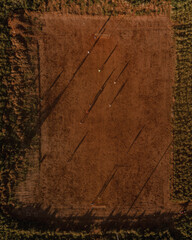drone view of soccer players in the dirt field 