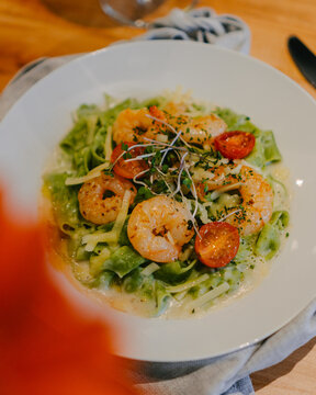 Prawns and salad launch over a wooden table on a luxury restaurant