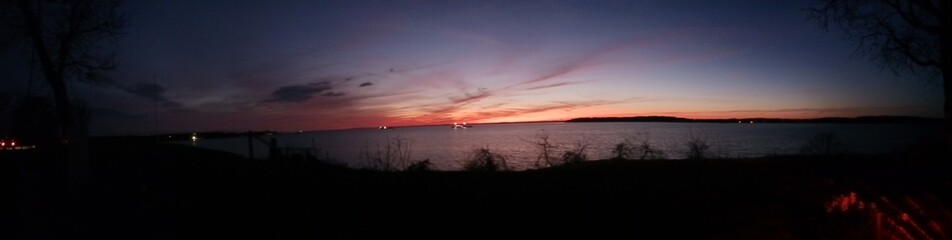 Panoramic view of sunset over a river.