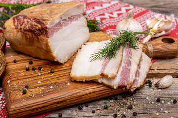 Smoked lard on wooden board. Sliced lard
