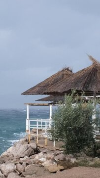 Powerful waves crashing the coast of Njivice, Croatia one day after Storm Ciar&aacute;n smashed into Krk Island. Beautiful rain curtain above the disquiet sea surface. Cinematic water splashes.