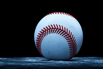 Detailed Close-Up of a White and Red Stitched Baseball on a Dark Background