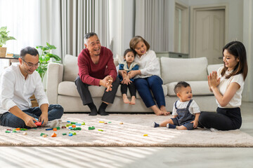 Portrait of enjoy happy love family asian father and mother playing with adorable little asian baby.newborn, infant.dad touching with cute son moments good time in a white bedroom.Love of family