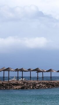 Powerful waves crashing the coast of Njivice, Croatia one day after Storm Ciar&aacute;n smashed into Krk Island. Beautiful disquiet blue sea surface on a rainy day. Cinematic water splashes.