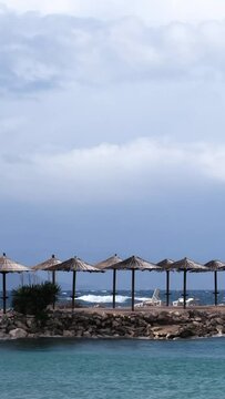 Powerful waves crashing the coast of Njivice, Croatia one day after Storm Ciar&aacute;n smashed into Krk Island. Beautiful disquiet blue sea surface on a rainy day. Cinematic water splashes.