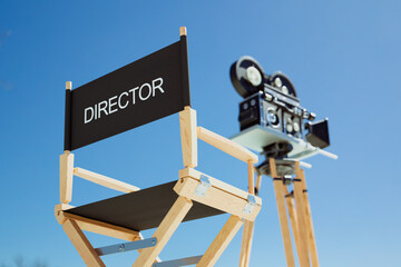Vintage Director's Chair and Classic Film Camera Under a Bright Blue Sky