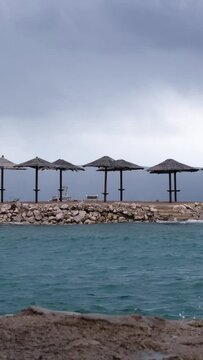 Powerful waves crashing the coast of Njivice, Croatia one day after Storm Ciar&aacute;n smashed into Krk Island. Beautiful disquiet blue sea surface on a rainy day. Cinematic water splashes.