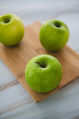 Green apples, granny smith on a bamboo cutting board