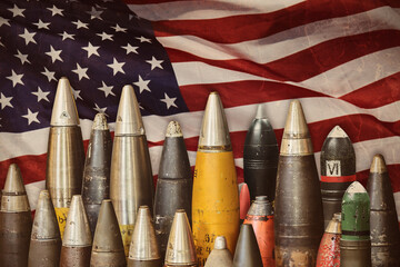 Military bombs and ammunition in front of a waving American flag - 767200477