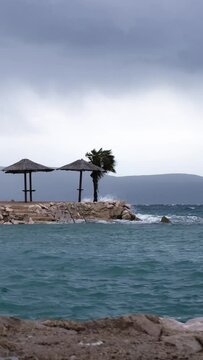 Powerful waves crashing the coast of Njivice, Croatia one day after Storm Ciar&aacute;n smashed into Krk Island. Beautiful rain curtain above the disquiet sea surface. Cinematic water splashes.