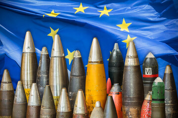 Military bombs and ammunition in front of a waving European Union flag - 767202263