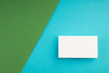 Business card blank over colorful background. Copy space for text. Top view.Business card blank over colorful abstract background. Corporate stationery branding mock-up. Copy space for text. Top view.