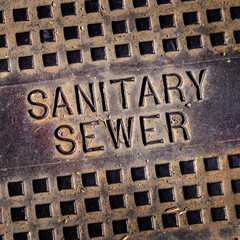 Sanitary Sewer Man Hole Cover Iron Lid Grungey Letters